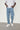 Model wearing Wolfe Denim Light Blue Baggy Jeans – relaxed fit, vintage wash, heavyweight denim, styled with white sneakers and an oversized tee.