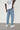 Model wearing Wolfe Denim Light Blue Baggy Jeans – relaxed fit, vintage wash, heavyweight denim, styled with white sneakers and an oversized tee.