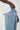 Model wearing Wolfe Denim Light Blue Baggy Jeans – relaxed fit, vintage wash, heavyweight denim, styled with white sneakers and an oversized tee.